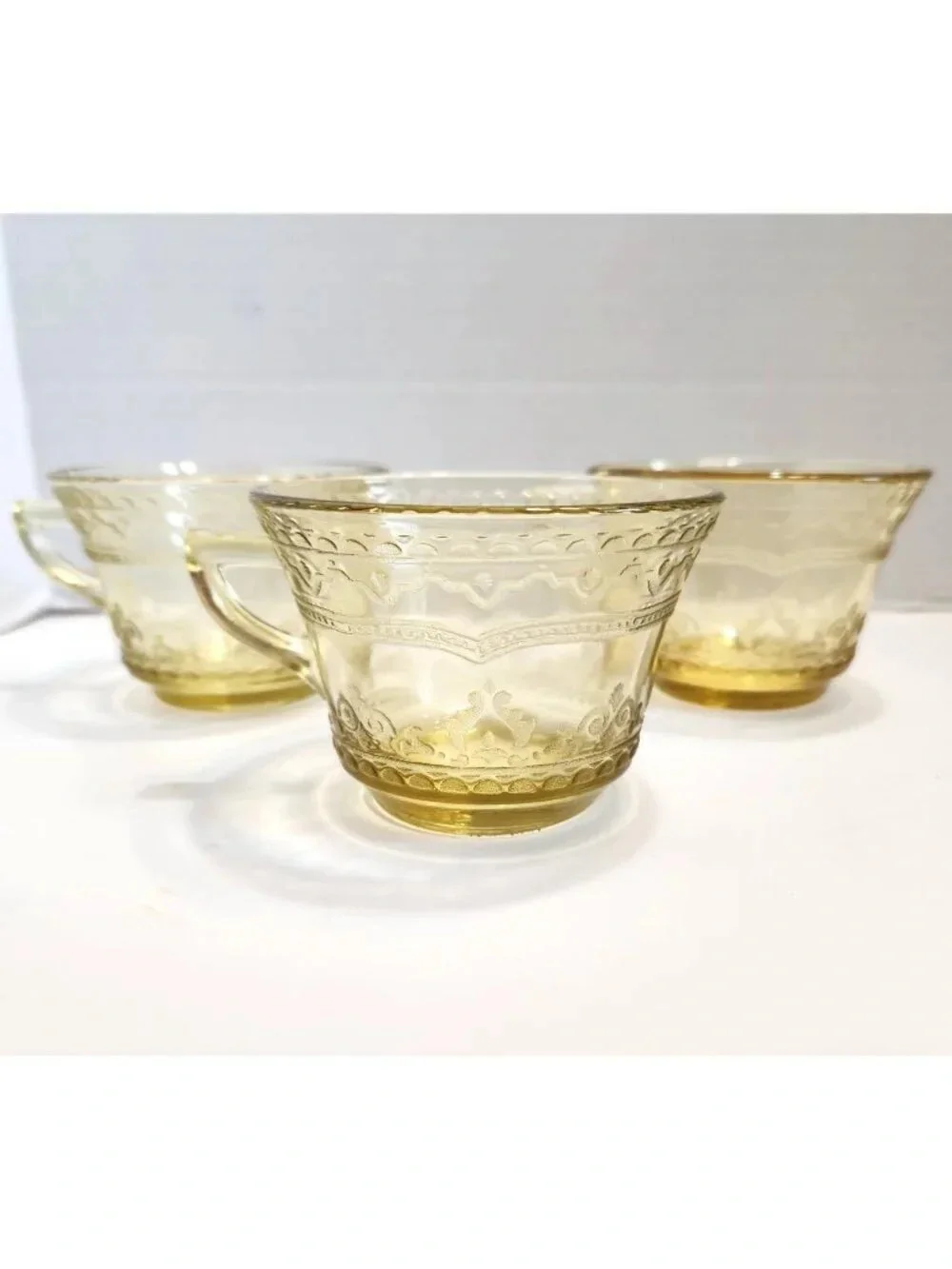Elegant Amber Glass Teacup with Etched Decorative Pattern